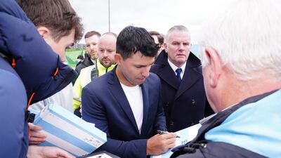 Sergio Aguero signs autographs.