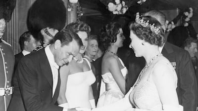 Frank Sinatra is presented to Queen Elizabeth at a movie premiere. PA