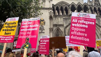 Demonstrators on Monday outside the Royal Courts of Justice, central London, protest against the government's plan to send some asylum seekers to Rwanda, while a High Court hearing over the policy is continuing. PA