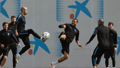 Barcelona’s Argentinian defender Javier Mascherano (third left) plays with Barcelona’s Brazilian defender Dani Alves (third right) during a training session at the FC Barcelona Joan Gamper Sports Center in Sant Joan Despi, near Barcelona on April 12, 2016, on the eve of their Champions League quarter-final second leg football match between Atletico de Madrid and FC Barcelona. / AFP / LLUIS GENE