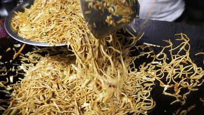 Above, a vendor fries noodles for customers in New Delhi. Nestle halted instant noodle sales in India when regulators said they contained unhealthy levels of lead. Kuni Takahashi / Bloomberg