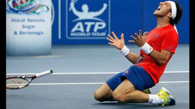 Juan Monaco of Argentina celebrates after defeating Julien Benneteau of France in the final of the Malaysian Open tennis tournament in Kuala Lumpur. Lai Seng Sin / AP Photo