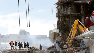 Rescuers standing at the smoking ruins of the Canterbury TV (CTV) building which collapsed during the 6.3 magnitude earthquake in Christchurch, February 24, 2011. AFP