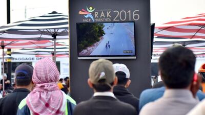 RAK half marathon runners’ families watch the race on big LED screens.