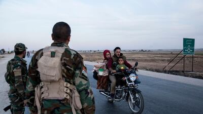 Syrian government troops amn a checkpoint town of Tal Tamr in northeast Syria. Syrian government troops moved into towns and villages in northern Syria on Monday, setting up a potential clash with Turkish-led forces advancing in the area as long-standing alliances in the region begin to shift or crumble following the pullback of U.S. forces. AP Photo