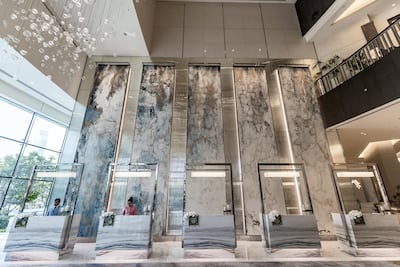 The lobby has plenty of interestingly patterned marble throughout and one of the 10 glass chandeleirs dotted around the five-star property. Chris Whiteoak / The National