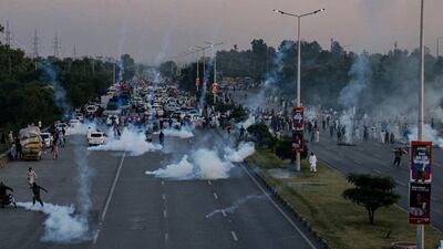 Police use tear gas to disperse PTI protesters, in the capital Islamabad. AFP