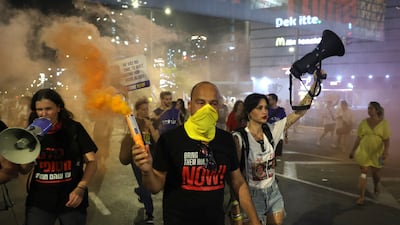 People light flares during an anti-coalition protest outside the Kirya military headquarters in Tel Aviv. EPA