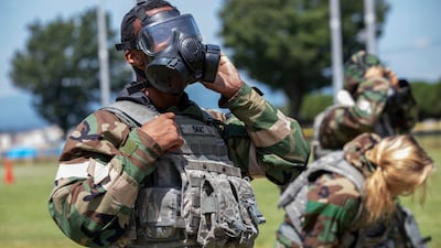 Senior Airman Antonio Gant dons mission-oriented protective posture (MOPP) gear during training at Yokota Air Base, Japan. Photo: US Air Force