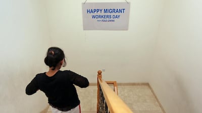A domestic worker who ran away from her abusive employer walks down a flight of stairs at a safe house in Dubai. Amy Leang / The National
