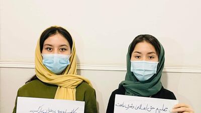 Campaigners hold placards to raise awareness of girls' education rights in Afghanistan.
