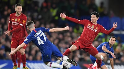 Billy Gilmour lunges into a tackle against Takumi Minamino. AFP