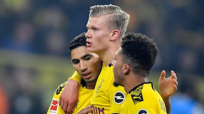 Dortmund's scorer Erling Haaland, center, celebrates his goal with teammates Jadon Sancho, right, and Achraf Hakimi. AP