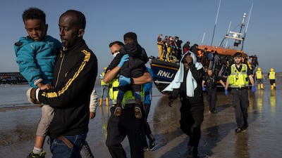 A group of migrants arrive on Dungeness beach in Kent, south-east England. The week has seen a major increase in migrant numbers due to fair weather. Getty Images