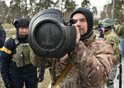 Members of the Ukrainian Territorial Defence Forces examine new weapons, including NLAW anti-tank systems and other portable anti-tank grenade launchers, in Kyiv. AFP