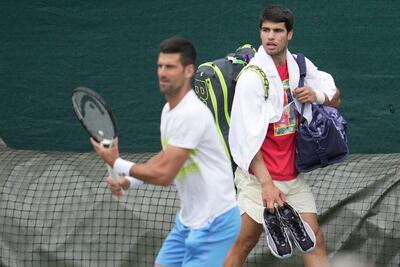 Novak Djokovic of Serbia, left and Carlos Alcaraz of Spain take part in a practice session ahead of the Wimbledon tennis championships. AP Photo