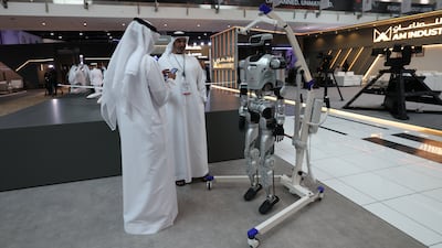 Visitors inspect the exhibition at the 7th UMEX and SimTEX in Abu Dhabi. EPA