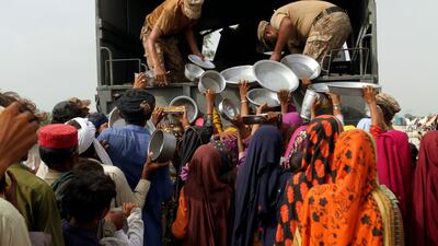 Troops distribute food and other essentials to the displaced people of flood-hit Rajanpur district in Punjab. AP
