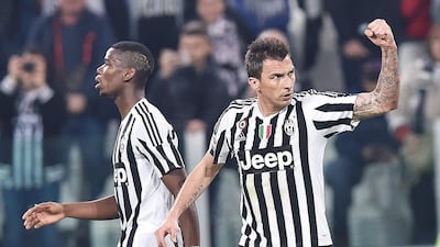 Mario Mandzukic, right, celebrates after scoring the winning goal for Juventus against Empoli. Di Marco / EPA