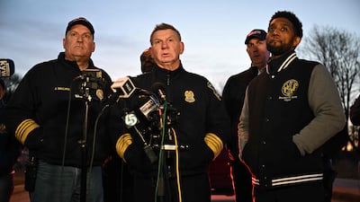 Baltimore Police commissioner Richard Worley, centre, Mayor Brandon Scott, right, and Fire Department chief James Wallace hold a press conference. AFP