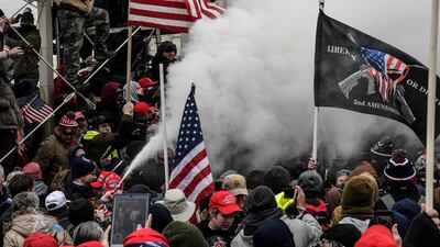 A Trump supporter sprays smoke. Reuters