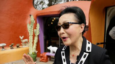 Homeowner Florence Fang talks with reporters after a news conference outside her Flintstone House. AP