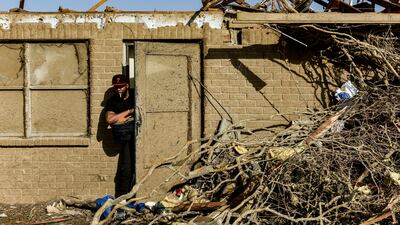A Silver City resident surveys the damage. AP