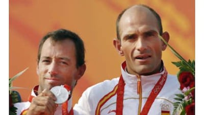 Spain's Iker Martinez, left, and Xabier Fernandez celebrate after winning the silver medal for the 49er men sailing competition.