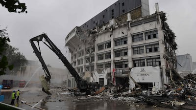 Demolition expert knock down the Workers' Stadium in Beijing. The stadium, originally built in 1959 and which later hosted football competition at the 2008 Beijing Olympic Games, is to be rebuilt. AFP