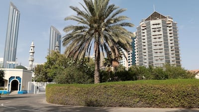 The green embassy in the capital is seemingly dwarfed by its lofty surroundings.