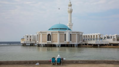 A couple sit in front of the Floating Mosque in Jeddah, Saudi Arabia. Getty Images