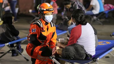 Handout picture released by Bomberos Volutarios shows Firefighters help evacuees settle in a temporary shelter in Santa Lucia Cotzumalguapa south Guatemala City. Some 370 people from a community based at the base of the Fuego volcano, in southwestern Guatemala, were evacuated on Monday following the increase in the volcanic activity of the colossus, the Civil Protection Agency reported. AFP