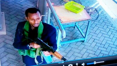 Security camera footage shows an armed attacker walking in the compound. AP
