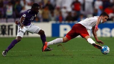 UAE's Al-Ain player Ahmed Barman, left, and Qatar's El-Jaish striker Abderrazzaq Hamed-Allah vie for the ball during their Asian Champions League group D football match at the Hazza bin Zayed Stadium in Al-Ain on February 24, 2016. AFP
