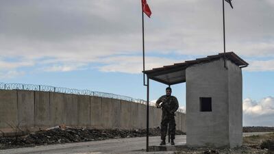 A Free Syrian Army oldier at a checkpoint near the Syrian village of Jandaris in the countryside of Afrin, along the wall on the northern border with Turkey, on December 18, 2021. AFP