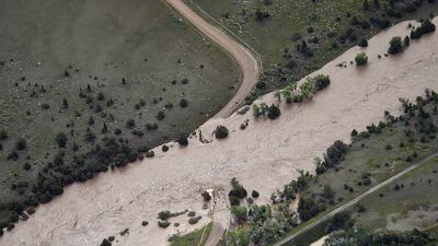 The bridge to Tom Miner Basin has been washed out as major flooding washed away roads and set off mudslides in Yellowstone National Park in Montana. The Billings Gazette / AP