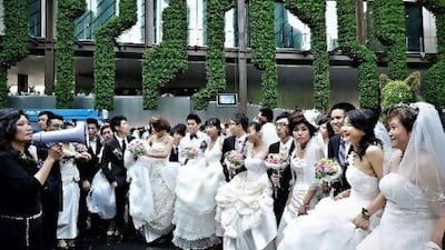Couples gather for a mass wedding at the at the French pavilion on the site of the World Expo 2010 in Shanghai in May.