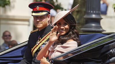 Britain's Prince Harry, Duke of Sussex and Britain's Meghan, Duchess of Sussex return in a horse-drawn carriage after attending the Queen's Birthday Parade, 'Trooping the Colour' on Horseguards parade in London. The ceremony of Trooping the Colour is believed to have first been performed during the reign of King Charles II. In 1748, it was decided that the parade would be used to mark the official birthday of the Sovereign. More than 600 guardsmen and cavalry make up the parade, a celebration of the Sovereign's official birthday, although the Queen's actual birthday is on 21 April. AFP / Niklas HALLEN