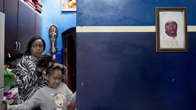 Afro Palestinian woman Ream Blala as combing the hair of her daughter Shahanda at their home on March 4, 2016. Their ancestors are originally from Chad.