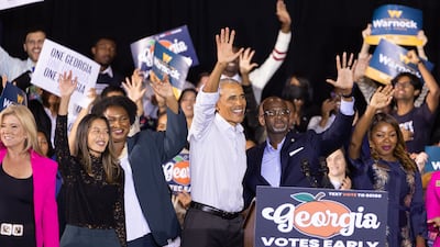 Mr Obama stands on stage with Georgia Democratic candidates, including Ms Abrams, Ms Nguyen, Jen Jordan and William Boddie. EPA
