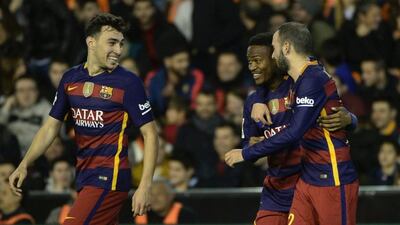 Barcelona's Cameroonian forward Wilfrid Kaptoum, centre, celebrates his goal with defender Aleix Vidal and forward Munir El Haddadi, left, during Spanish Copa del Rey semi-final second leg match against Valencia at the Mestalla in Valencia on Wednesday night. Jose Jordan / AFP