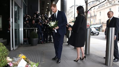 The couple add bouquets of flowers to a pile of floral tributes at the New Zealand High Commission in London. AFP