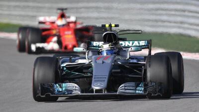 Mercedes' Valtteri Bottas, front, and Sebastian Vettel, in red, compete in the Formula One Russian Grand Prix at the Sochi Autodrom circuit in Sochi on April 30, 2017. Alexander Nemenov / AFP