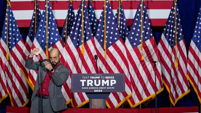 A campaign worker makes some final adjustments before former president Donald Trump arrives at a caucus night party in Des Moines. AP