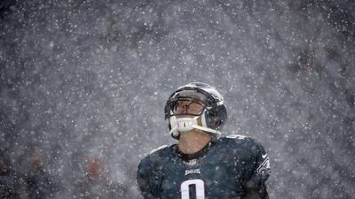 Philadelphia quarterback Nick Foles stares up into the snowfall. Matt Rourke / AP