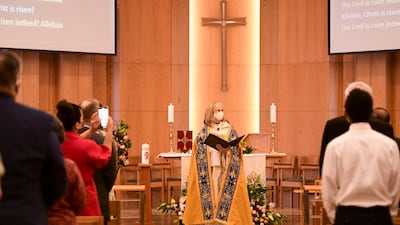 Rev Christine Trainor conducts the first Easter Sunday mass at St. Andrew's Centre in Mushrif, Abu Dhabi. Khushnum Bhandari / The National