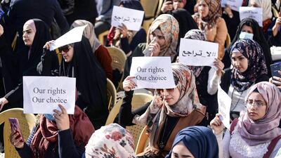 Protesters hold up signs reading "no retreat" and "our rights, our choice". AFP
