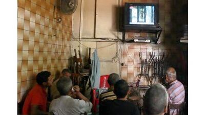 Men in Cairo watch the trial of Egypt's former president, Hosni Mubarak, his two sons, Alaa and Gamal, and the former interior minister, Habib Al Adli, on state television this summer.
