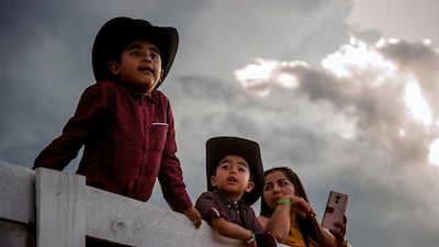 A family watches horses warm up for races at the Kentucky Downs event in Franklin, USA. Bac Totrong / AP Photo