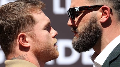 Canelo Alvarez shoves Caleb Plant during a face-off. AFP